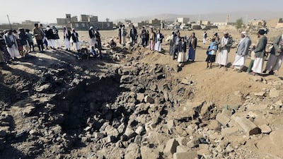 People gather around a crater caused by an air strike in Amran province, north-west of the Yemeni capital Sanaa on April 12, 2015. Khaled Abdullah/Reuters