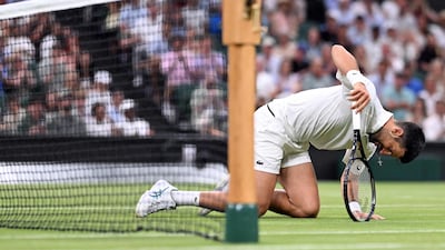 Serbia's Novak Djokovic is left on his knees in his second round Wimbledon match against Greece's Stefanos Tsitsipas. AFP