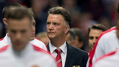 Manchester United's new manager Louis van Gaal, centre, takes to the touchline before his team's pre season friendly soccer match against Valencia at Old Trafford Stadium, Manchester, England, Tuesday Aug. 12, 2014. (AP Photo/Jon Super)