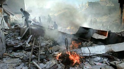 Haitians walk through collapsed buildings near the iron market in Port-au-Prince on January 31, 2010. AFP PHOTO / JEAN-PHILIPPE KSIAZEK
