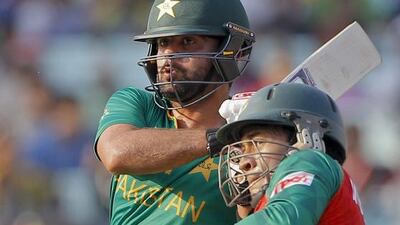 Pakistan’s Ahmed Shehzad plays a shot as Bangladesh’s Mushfiqur Rahim reacts during their ICC World Twenty20 2016 cricket match in Kolkata, India, Wednesday, March 16, 2016. (AP Photo/ Bikas Das)