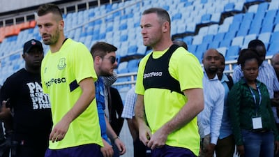 Everton's Wayne Rooney and Morgan Schneiderlin arrive for a training session at the National stadium in Dar es Salaam, Tanzania.