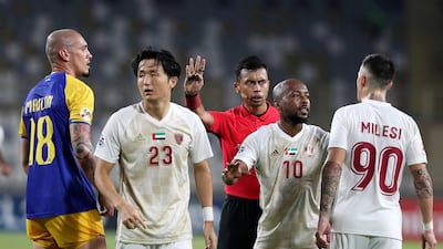 Referee Muhammad Taqi tries to calm things down. Chris Whiteoak / The National