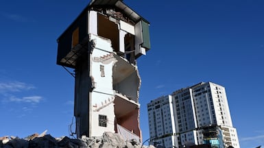 The remnants of a three-storey house still standing after demolition to make way for an expanded road network in Hanoi, Vietnam. AFP