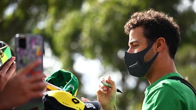 McLaren driver Daniel Ricciardo of Australia arrives at the circuit and signs autographs for fans. Getty