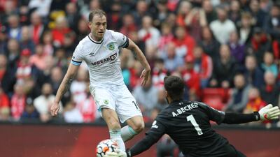 Liverpool goalkeeper Alisson Becker saves from Burnley's Ashley Barnes. Reuters