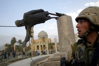 A US soldier watches as a statue of Iraq's ousted president Saddam Hussein falls at Firdos Square in central Baghdad, in 2003. Reuters