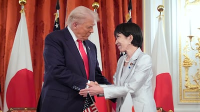 Mr Trump and Ms Takaichi a signing ceremony at Akasaka Palace in Tokyo. The US leader complimented his Japanese counterpart on 'a very strong handshake'. AP