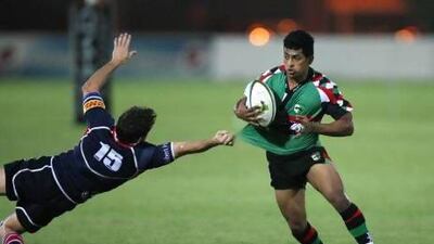 Abu Dhabi, United Arab Emirates, Sep 28, 2012 - IMAD REYAL (green) from Abu Dhabi Harlequins during a match against Jebel Ali Dragons at Zayed Sports City. ( Jaime Puebla / The National Newspaper )
