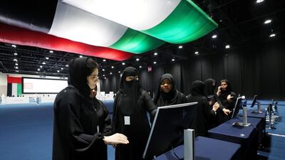 Emiratis are shown how to vote on a test system in Abu Dhabi. The electorate is much bigger this year - about 337,000 citizens are eligible compared to 224,000 in 2015 - meaning that many are voting for the first time. Chris Whiteoak / The National