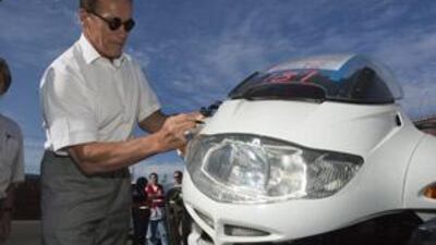 Arnold Schwarzenegger autographs a state-surplus BMW motorcycle for auction as part of the Great California Garage Sale.