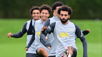 Liverpool's Egyptian midfielder Mohamed Salah (R) and teammates attend a training session at the Axa training centre in Kirkby, north of Liverpool in north-west England on September 14, 2021, on the eve of their UEFA Champions League, Group B football match against AC Milan. (Photo by Paul ELLIS / AFP)