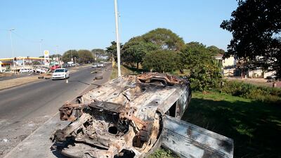 A burnt out vehicle alongside a road in Phoenix, near Durban, South Africa, Friday, July 16, 2021, after violence in the town. South Africa's army has begun deploying 25,000 troops to assist police in quelling weeklong riots and violence sparked by the imprisonment of former President Jacob Zuma.