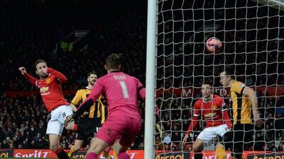 Manchester United's Juan Mata scores the opening goal in his team's 3-0 FA Cup fourth round replay win over Cambridge United on Tuesday. Nigel Roddis / EPA