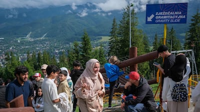 Tourists walk up Gubalowka hill to enjoy a view of Zakopane and the Tatra Mountains