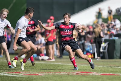 File photo of Dubai College A team, in red and black, in the Gulf U19s at Dubai Rugby Sevens in 2018. Reem Mohammed / The National