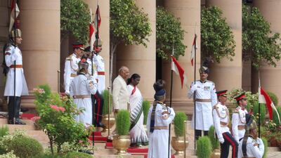 Ms Murmu and Mr Kovind arrive at the Central Hall of Parliament for the swearing-in ceremony. Reuters