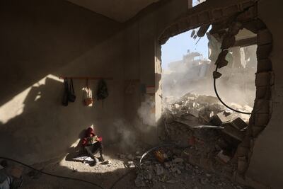A boy sits in the rubble of a house following overnight Israeli strikes at the Nuseirat refugee camp in central Gaza. AFP