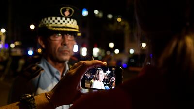 A journalist films with his smartphone as Barcelona's Mayor Ada Colau speaks to the press. Javier Soriano / AFP Photo