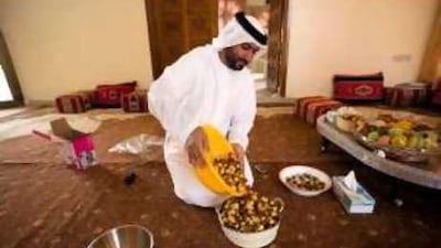 Ahmed al Murar checks the dates he will enter in the Liwa Date Festival, which began yesterday and continues until July 26.
