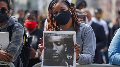 A person holds up a newspaper with a photo of musician and actor Earl Simmons, known as DMX, outside the Barclays Centre in Brooklyn, New York City. Reuters