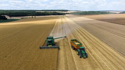 A combine harvester unloads barley into a tractor trailer during the harvest in Ailly-sur-Noye, France. Bloomberg