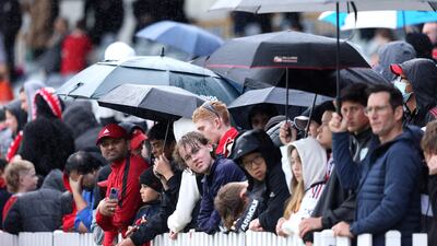 Manchester United fans brave the rainy conditions to watch an open training session in Perth on July 21, 2022, ahead of the tour match against Aston Villa. AFP