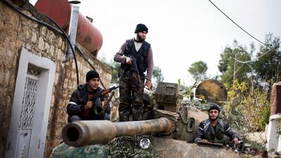 Kurdish opposition fighters occupy a tank stolen from the Syrian Army, in Fafeen village, north of Aleppo.