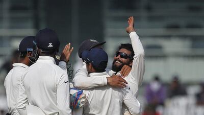 Ravindra Jadeja, right, celebrates with teammates after dismissing Enlgand batsman Ben Stokes. Tsering Topgyal / AP Photo