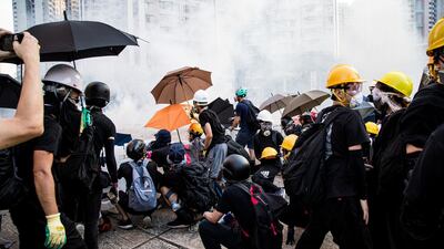 Hong Kong's pro-democracy protesters during a standoff with the police, using umbrellas and roadblocks to resist the police's offense and tear gas. Xun Yuan for The National