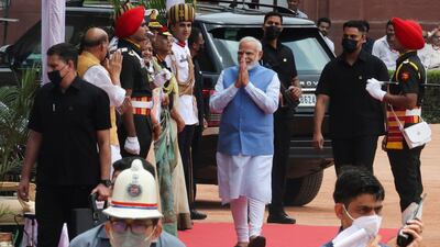 Mr Modi greets officials after arriving at the venue of the swearing-in ceremony. Reuters