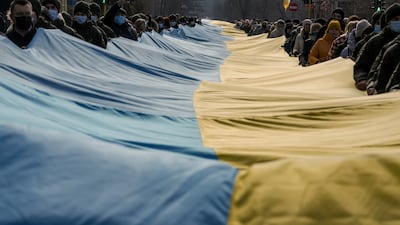 A large Ukrainian flag is carried through Sievierodonetsk. AP Photo