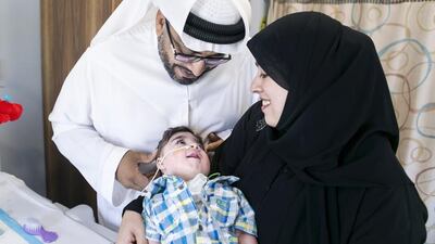 Nada and Noaman Al Ansari with Ali, who is cared for at Cambridge Medical and Rehabilitation Centre. Reem Mohammed / The National
