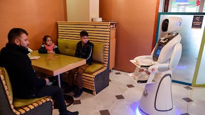 Timea delivers food to customers at a restaurant in Kabu. AFP