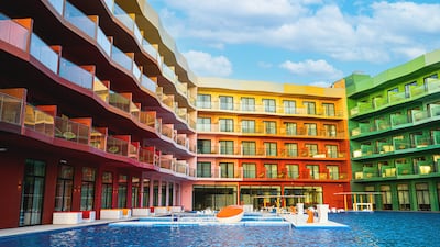 The Cote d’Azur Monaco Hotel looms over a large swimming pool, complete with submerged loungers. Photo: Cote d’Azur Monaco Hotel / Heart of Europe