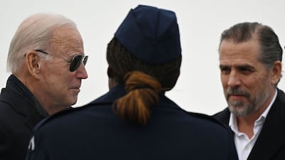 US President Joe Biden and his son Hunter, right, speak to a member of the National Guard in February. AFP