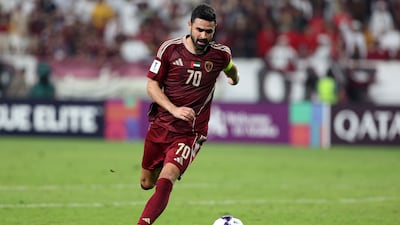 Al Wahda's Omar Khribin runs with the ball during the match against Al Sadd.