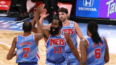 Kevin Durant, James Harden, Joe Harris, and DeAndre Jordan of the Brooklyn Nets high-five during the first half against the Orlando Magic. AFP