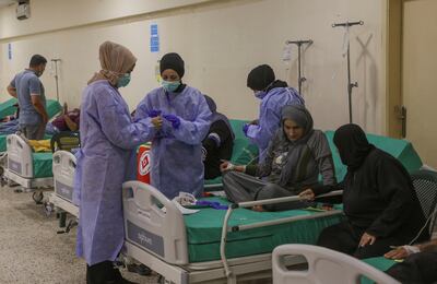 Health workers attend to suspected cholera patients inside a field hospital in Bebnine, Akkar district, northern Lebanon. Reuters