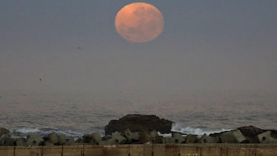 The moon rises over the harbour of the coastal town of Lambert's Bay, South Africa, on Monday, November 14, 2016. The brightest moon in almost 69 years will be lighting up the sky this week in a treat for star watchers around the globe. Schalk van Zuydam / AP Photo