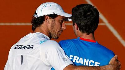 Argentina's Juan Monaco, left, consoles Gilles Simon, right, after the latter's loss in the Davis Cup.
