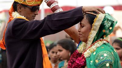 An Indian visually impaired bridal couple participate in a mass marriage at the Andh Kanya Praksh Gruh in Ahmedabad. Four Hindu couples and a Muslim couple were wedded using financial assistance from donors. Sam Panthaky / AFP Photo