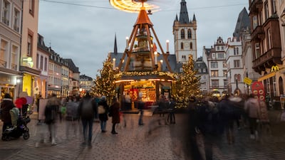 People visit a Christmas market in the German city of Trier. AP