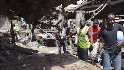 Rescue workers are pictured at the site of a suicide bomb attack at a market in Maiduguri, Nigeria, on June 2, 2015. Bomb attacks have resurged since the inauguration of newly elected Muslim president Muhammadu Buhari last week, with 80 people killed in a series of attacks over the past few days. Jossy Ola/AP Photo
