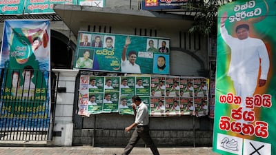 A man walks past the posters of Sajith Premadasa, Sri Lanka's presidential candidate of the New Democratic Front alliance, in Colombo, Sri Lanka. Reuters