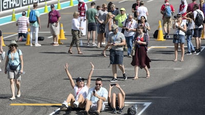 Fans walk through the pit lane during previews for the Abu Dhabi Formula One Grand Prix at Yas Marina Circuit in Abu Dhabi on November 23, 2017. Christopher Pike / The National
