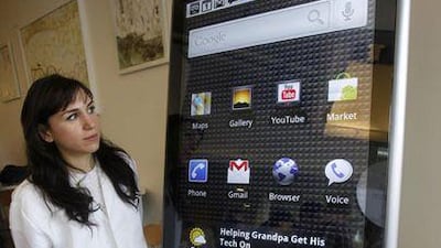 Google employee Sara Rowghani stands next to an enlarged model of the Nexus One phone at a demo in California.