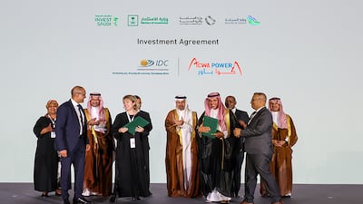 Paddy Padmanathan, of Acwa Power, Joanne Bate, of Industrial Development Corporation of South Africa, and other executives sign an agreement to explore green hydrogen projects. Photo: Acwa Power