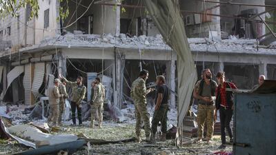 Turkey-backed Syrian fighters inspect the site of the explosion. AFP