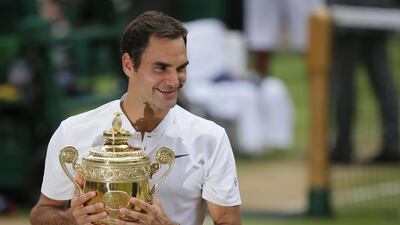 Roger Federer holds the trophy after defeating Marin Cilic to win the men's singles final at Wimbledon on Sunday. Tim Ireland / AP Photo